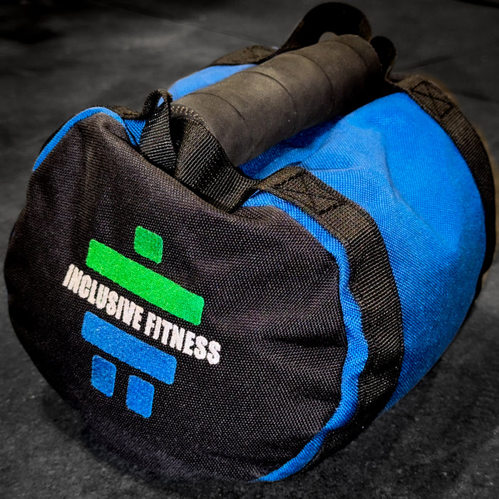 Single Arm Throwing Bag in black and blue with a padded handle and the Inclusive Fitness logo, on a gym floor